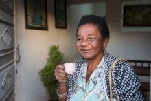 Ethnic senior woman with cup of coffee